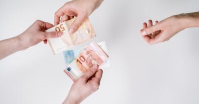 Close-up of hands exchanging euro banknotes, symbolizing currency trade and financial transactions.