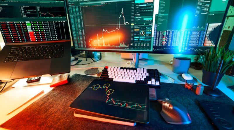 A trader's desk is lit up with charts.